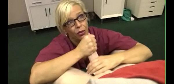  Cumcovered nurse working on patients cock